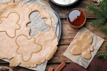 Flat lay composition with homemade gingerbread man cookies on wooden table