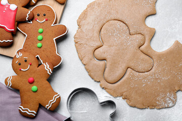 Flat lay composition with homemade gingerbread man cookies on light grey table