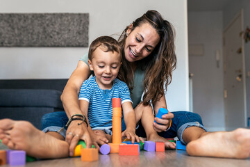 Mother playing with her son at home