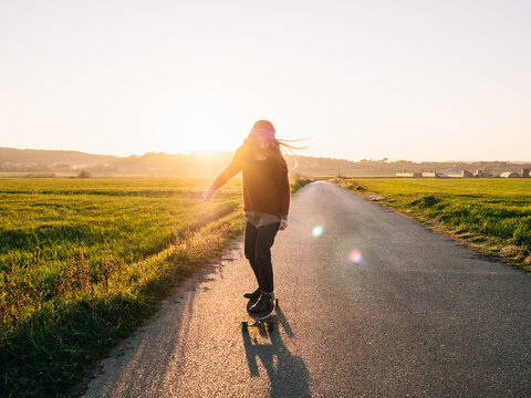 Woman skating into the sun