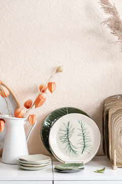 Artisan crockery and flowers on table