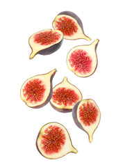 Falling tasty ripe figs on white background