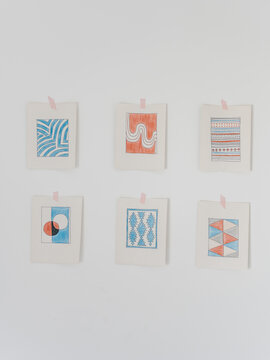 Paper sketches with simple ornaments on wall