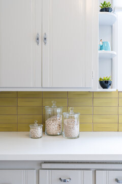 Old Fashioned Kitchen Details Of Carved Wooden Cabinets And Yellow Ceramic Backsplash. 