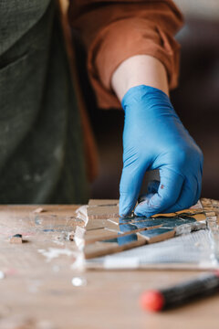 Crop artist making reflective mosaic
