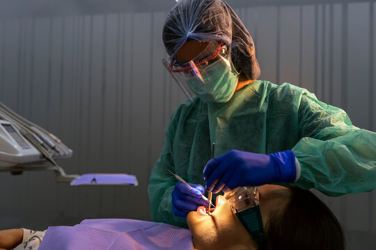 Dentist With A Patient During A Dental Intervention.