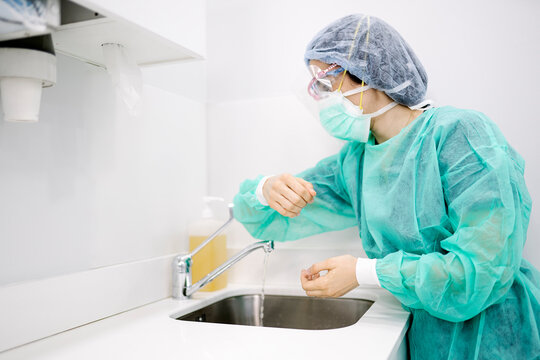Unrecognizable doctor washing hands