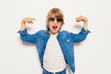 Caucasian kid in studio looking at camera.