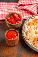 Vertical view of chopped fresh tomato and chickpeas and rice meal