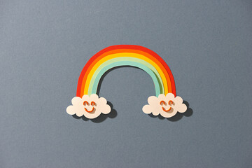 Cloud and Rainbow in blue sky Paper cut art Style the concept is season day