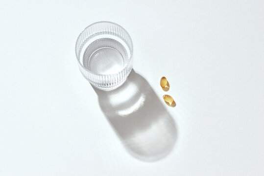 Capsules fish oil omega-3 and glass of water