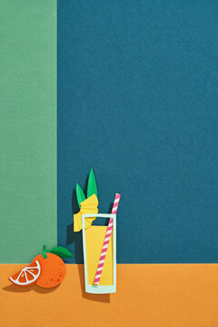 Fresh multi fruit juice with ice in a glass with orange on colorful background