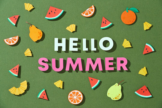 Word Hello Summer over tropical paper cut leaves and fruits background.