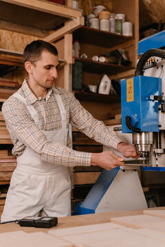 Carpenter putting drill on CNC machine