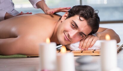 Fototapeta na wymiar Young handsome man during spa procedure