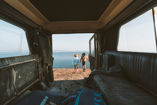 Young couple holding hands while waking at beach