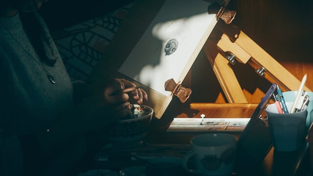 close up of artist sharpening her pencils in the sun