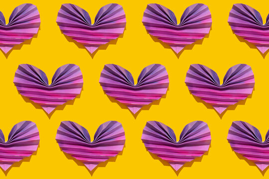 Pattern of pink and purple origami hearts