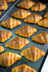 lots of croissants on a iron tray