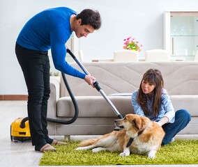 Husband cleaning house from dog fur