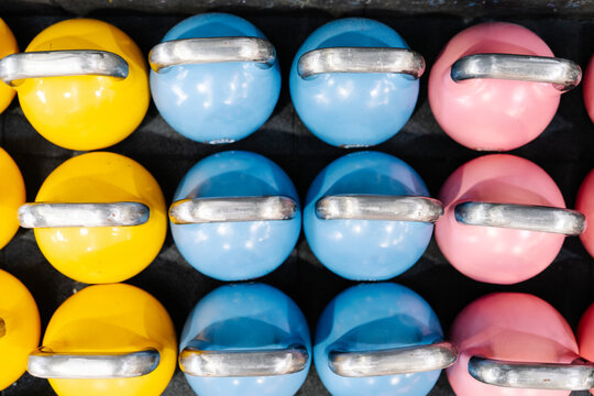 Close-up of colorful kettlebells on table in gym