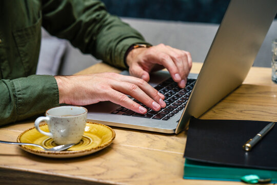 Businessman working on laptop while sitting at cafe