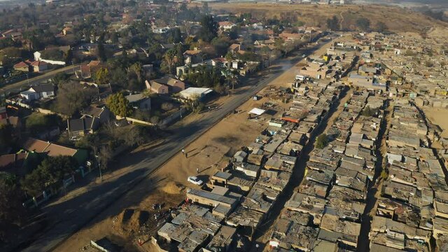 Inequality.Aerial fly over view of an informal settlement Kya Sands squatter camp right next to middle class suburban housing, Gauteng Province, South Africa