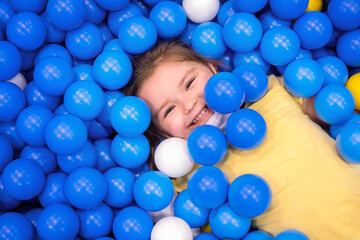 Fototapeta na wymiar child n multi-colored ball in playgroup