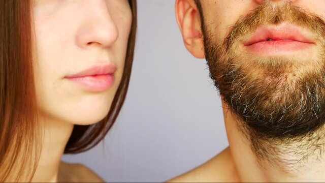 One very beautiful girl kissing a bearded man in the cheek close-up
