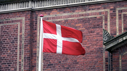 Danish flag with brick wall background in copenhagen Denmark
