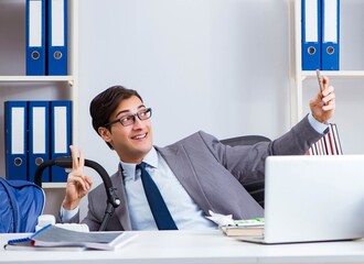 Businessman looking after newborn baby in office