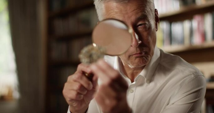 4k, Goldsmith examining precious stone with a magnifying glass