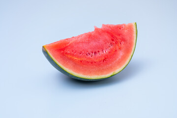 Big piece of watermelon on blue table