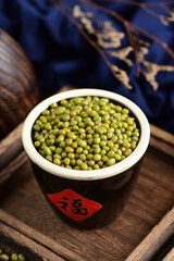 Mung beans on the background of retro Chinese style.The Chinese meaning in the picture is happiness