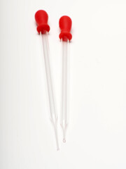 close up shoot of glass pipette with red rubber on a white isolated background