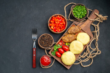 Tasty cutlets chopped vegetables greens for dinner on dark background image stock photo