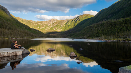 Young couple posing in front of the lake of the Americans, in the Gaspésie national park, Canada