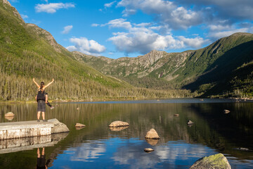 Young couple standing in front of the lake of the Americans, in the Gaspésie national park, Canada
