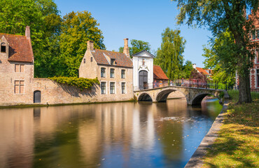 Classic view of the historic city center with canal in Brugge (Bruges), West Flanders province, Belgium. Cityscape of Bruges