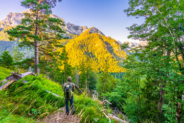 Fototapeta premium Photographer hiking mountain in German alps 