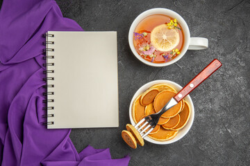 top view sweet pancakes with cup of tea on dark background sweet milk cake