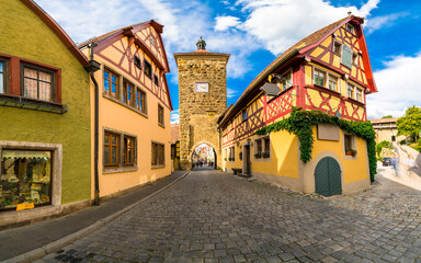 Fototapeta na wymiar Clock tower at Spitalgasse street in Rothenburg ob der Tauber. Bavaria, Germany