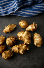 Close up of Fresh Jerusalem Artichokes on Dark Table