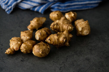 Close up of Fresh Jerusalem Artichokes on Dark Table