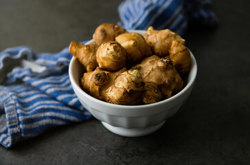 Close up of Fresh Jerusalem Artichokes on Dark Table