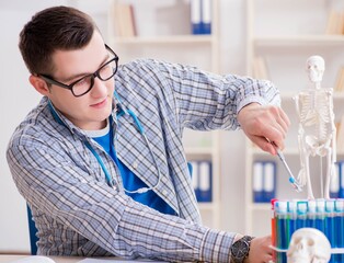 Young student studying chemistry in university