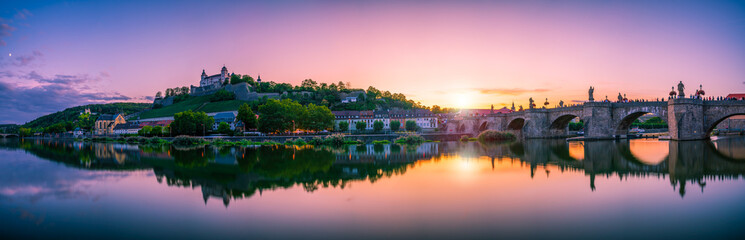 Naklejka premium Beautiful sunset panorama of Wurzburg with Marienberg Fortress and reflection river. Germany