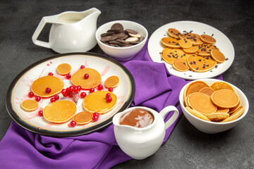front view delicious little pancakes with cookies on dark background milk dessert sweet