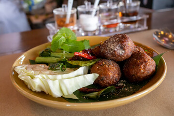 Larb Mood Tod, Thai crispy pork and herb balls, soft focus