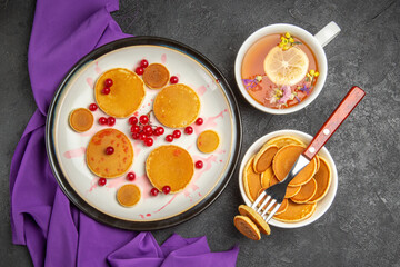 top view little pancakes with cup of tea on dark background cake dessert sweet